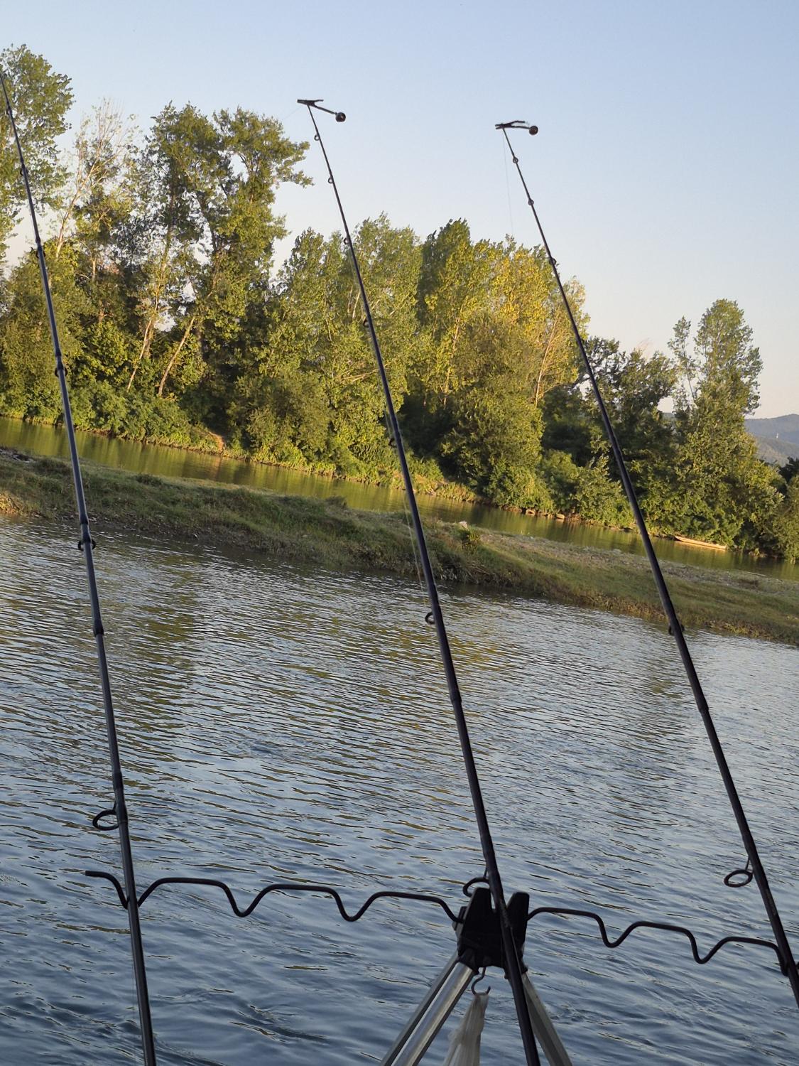 Fishing rods by the river at sunset